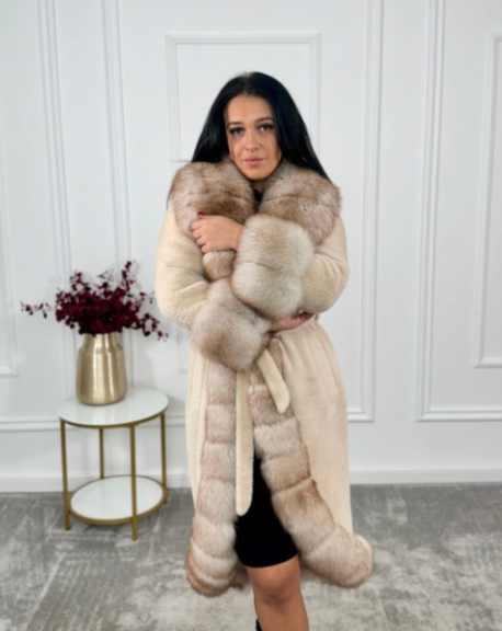 Close-up view of the woman in the Oya Alcantara coat with a soft embrace of the fox fur, highlighting the garment's texture and quality.