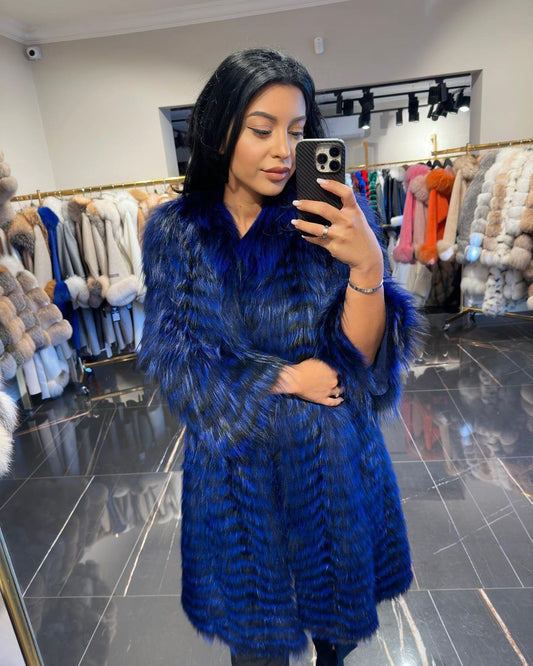 Fashion-forward Karina blue fox fur cardigan worn by a stylish woman taking a mirror selfie in a boutique. 
