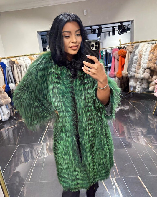 Fashion-forward Karina blue fox fur cardigan worn by a stylish woman taking a mirror selfie in a boutique. 