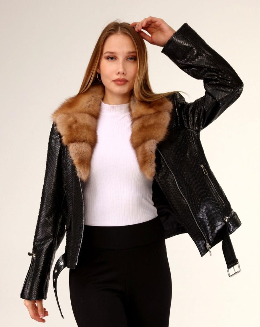 Stylish ILINKA jacket crafted from premium python leather with a luxurious mink fur collar, modeled with elegance.