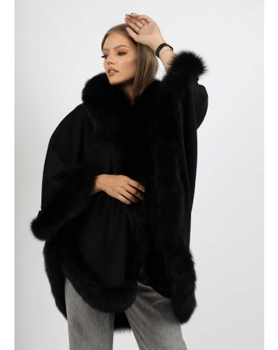 Model wearing Ophelia black fox fur hooded cape, showcasing the lavish fur trim.