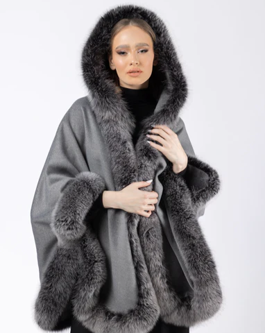 Model wearing Ophelia grey fox fur hooded cape, showcasing the full hood and lavish fur trim.