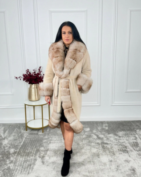 Elegant woman modeling the Oya Alcantara coat with luxurious fox fur trim in a classic standing pose.