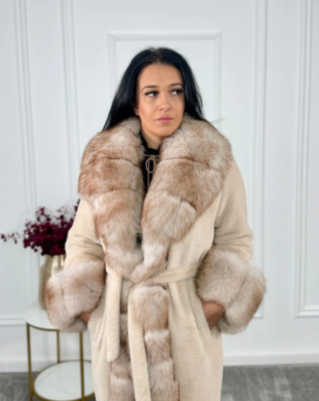 Portrait of the Oya Alcantara coat worn open, revealing the detailed structure and luxurious fox fur collar.